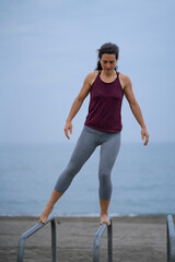 female athlete exercising on the beach 