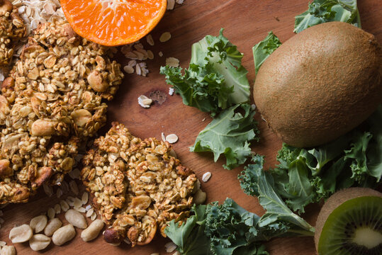 healthy food fruit grains lettuce leaves on wooden background flat lay