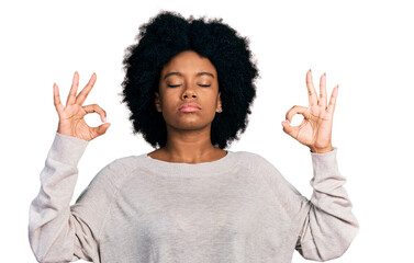 Young african american woman wearing casual clothes relax and smiling with eyes closed doing meditation gesture with fingers. yoga concept.