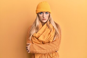 Young caucasian woman wearing wool winter sweater and cap skeptic and nervous, disapproving expression on face with crossed arms. negative person.