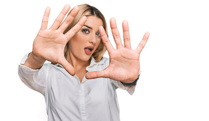 Young caucasian woman wearing casual clothes doing frame using hands palms and fingers, camera perspective