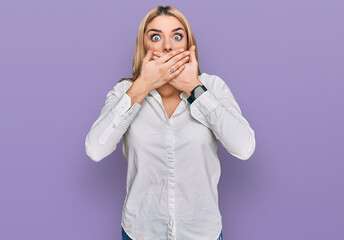 Young caucasian woman wearing casual clothes shocked covering mouth with hands for mistake. secret concept.