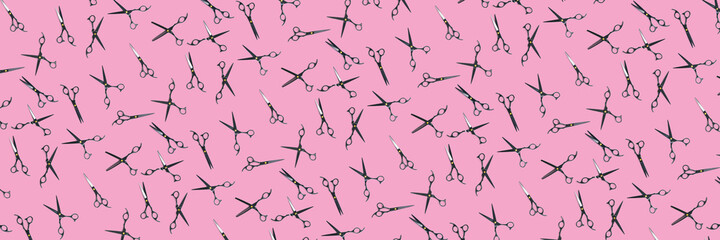 Background of black scissors. professional hairdresser black scissors isolated on pink. Black barber scissors, close up. pop art background, for prints or posters. not seamless pattern