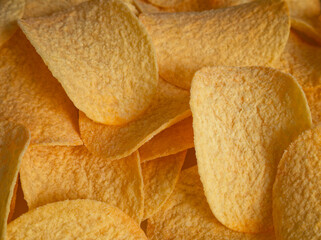 Potato chips close-up in direct sunlight - top view