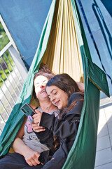 mother and daughter together with a smartphone