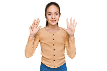 Beautiful brunette little girl wearing casual sweater showing and pointing up with fingers number...