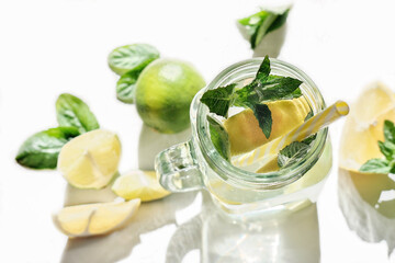 fresh lemon and mint drink in a jar. summer cold infused water for freshness. lime and lemon slices. healthy drinks for wedding or birthday party
