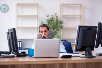 Young male employee working in the office