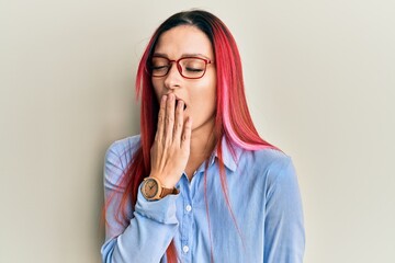 Young caucasian woman wearing casual clothes and glasses bored yawning tired covering mouth with hand. restless and sleepiness.