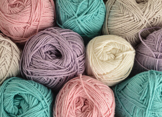 pastel woolen balls in basket closeup for handicrafts