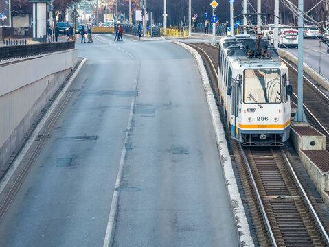 Bucharest, Romania - 01.22.2021: City Tram No.41 belonging to Bucharest Transit Corporation( Societatea de Transport Bucuresti -STB) on tracks entering in the Lujerului underground. passage.