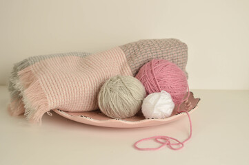 Fototapeta na wymiar pink and white woolen balls with woolen scarf