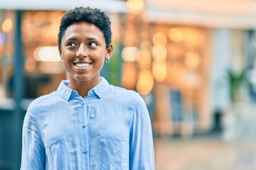 Young african american girl smiling happy standing at the city.