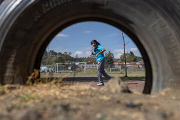 woman running on a park of a poor town in mexico