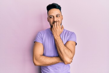 Young arab man wearing casual clothes looking stressed and nervous with hands on mouth biting nails. anxiety problem.