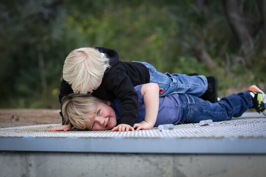 Cute Little Blonde Brothers Play Fighting And Wrestling In Nature