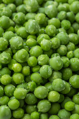 Many grains of ripe green peas with water drops, as background, food texture