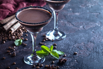glasses of cream coffee cocktail or chocolate martini on black background