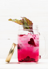Summer infused detox.cold lemonade with beets in a glass jar on a white wooden background