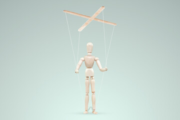Male hand, puppeteer controls the puppet puppet with strings. The concept of shadow government, world conspiracy, manipulation, control.