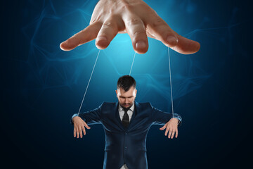 Male hand, puppeteer controls the puppet puppet with strings. A doll on her knees. The concept of...