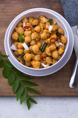 cooked chickpeas or grams dish, also known as garbanzo beans or egyptian peas boiled and tempered with oil and coconut, healthy vegetarian dish