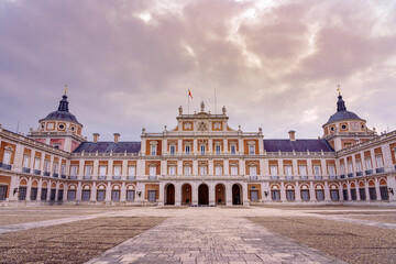 Fototapeta na wymiar Main facade of the royal palace of Aranjuez with its rows of windows and two domes. Madrid.