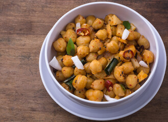 cooked chickpeas or grams dish, also known as garbanzo beans or egyptian peas boiled and tempered with oil and coconut, healthy vegetarian dish