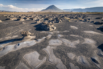 Mudflats close to Lake Natron with Ol Doinyo Lengai volcano in the background; Tanzania
