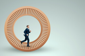 A man in a suit runs in a hamster wheel. The concept of liberation from slavery, life, business,...