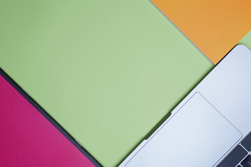 Business, office, student, education flat lay, table top. Colorful notebook, laptop on green background