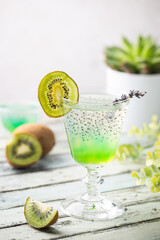 Cold cocktail kiwi drink in a glass with fresh fruits on white background