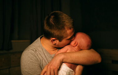 father holding a crying baby