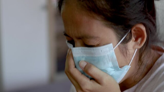 asian woman wearing medical mask have a cough, sneeze, sick person - Powered by Adobe