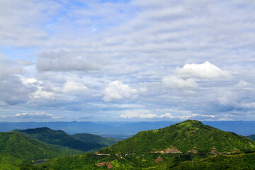 Beautiful landscape view of mountain, small village and road or street for travel with blue sky and cloud in north of Thailand. Beauty in nature and live with natural. 