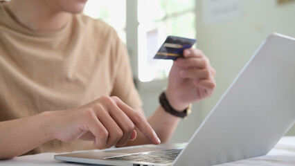 business hands holding credit card and using labtop, world currencies,wallet cryptocurrency, fintech financial technology, internet payment, money exchange, financial digital banking concept (fintech)