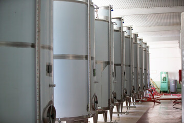Industrial metal tanks for wine at a plant for the production of alcoholic beverages.