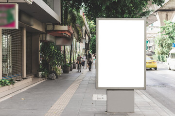 big blank billboard white LED screen vertical outstanding in the city side the road traffic for...