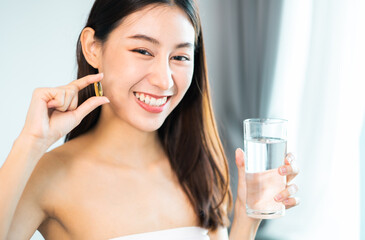 young beauty asian  Pregnant woman  holding vitamin pill isolated at home.healthcare and medical concept.