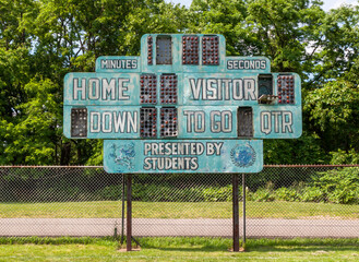 An old football scoreboard on a field in Swissvale, Pennsylvania, USA on a sunny day