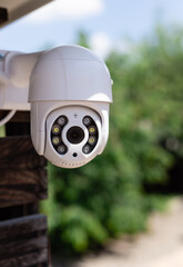 IP CCTV wifi surveillance camera on backyard background. Concept of home security technology....