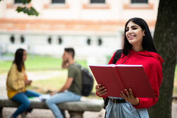 Student reading a book outdoor