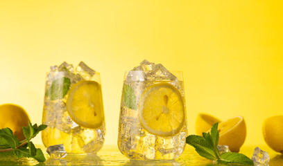 Lemonade with fresh slice lemon and mint leaves. Summer homemade drink. Citrus cold refreshing...