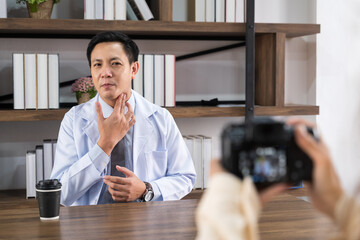 Doctor are describing or asking patients for symptoms remotely.He demonstrated how to check for initial illnesses by recording videos as content in telemedicine,remotely and healtcare concept.