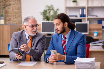 Two male employees in remuneration concept