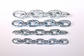 Various chains on white background and with blur