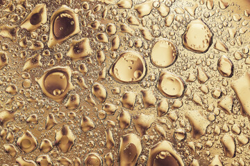 Abstract golden background of water and oil drops. Beautiful luxury backdrop for your design.