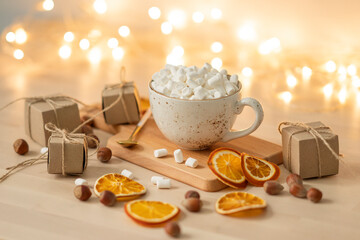 Obraz na płótnie Canvas Cup of hot chocolate with marshmallows on festive background.