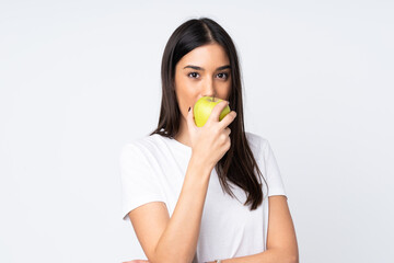 Young caucasian woman isolated on white background eating an apple