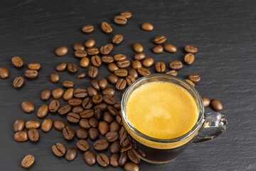 glass cup with espresso and coffee beans